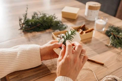 Close-up of a young woman's hands decorating candles for Christmas or New Year Stock Photos