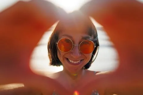 Close-up of a young woman's hands making a heart shape. Portrait of a beautif Stock Photos