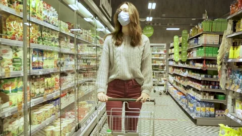 Close-up of a young woman's hands moving a grocery cart through the aisles of a Stock Footage 170777821