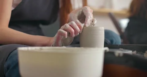 Close-up of young woman's hands in pottery studio using pottery wheel, handmade Stock Footage 155358453