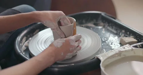 Close-up of young woman's hands in pottery studio using pottery wheel, handmade Stock Footage 155358837