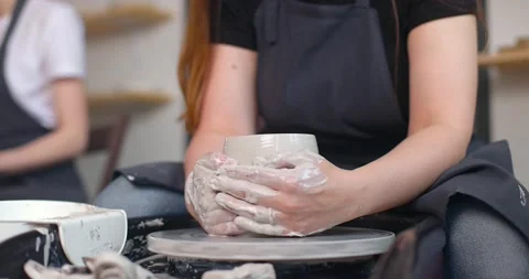 Close-up of young woman's hands in pottery studio using pottery wheel, handmade Stock Footage 156466780