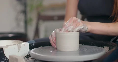 Close-up of young woman's hands in pottery studio using pottery wheel, handmade Stock Footage 157188047