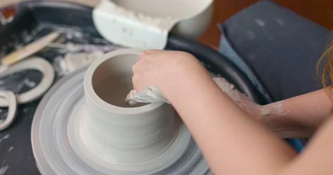 Close-up of young woman's hands in pottery studio using pottery wheel, handmade Stock Footage 160423909