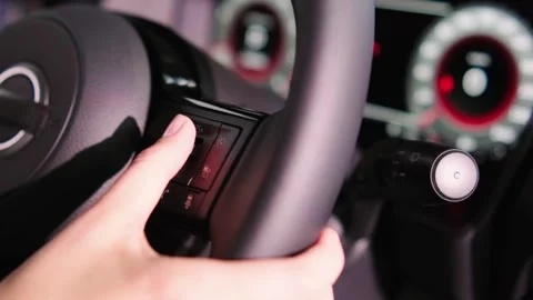 Close-up of a young woman's hands on the steering wheel of an electric car. Stock Footage 274982437