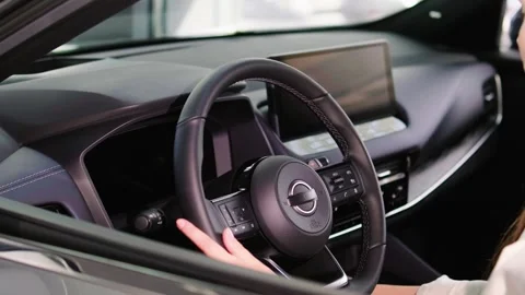 Close-up of a young woman's hands on the steering wheel of an electric car. Stock Footage 274982466