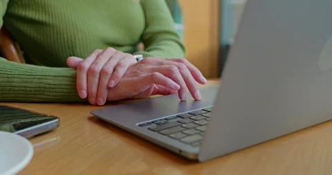 Close up of young woman's hands using touch pad on laptop in cafe. Stock Footage 254556941