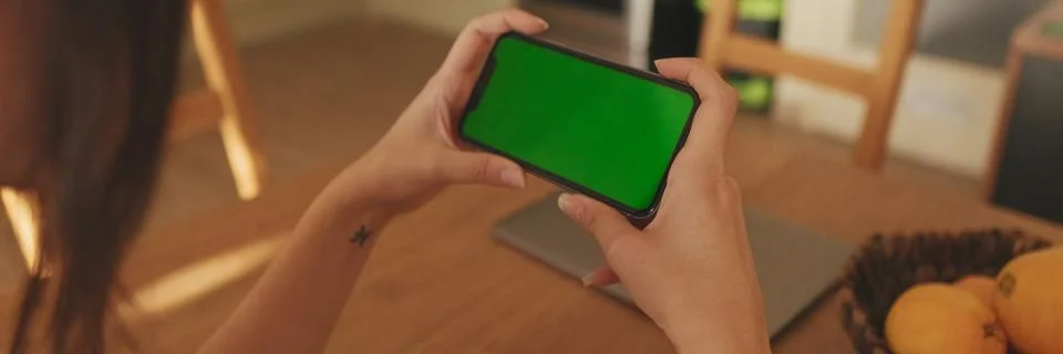 Close-up of young woman's hands using mobile phone green screen chroma key .. Stock Photos
