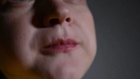 Close up of a young woman's lips as she eats corn rings. 動画素材 337069364