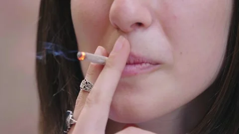 cigarette between lips Tommy's placement is oddly satisfying. The rub has become idiosyncratic but functional preventing the cigarette from sticking to his : r/PeakyBlinders Close-up of young woman's lips