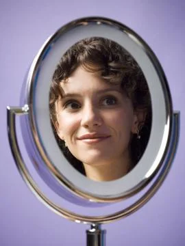 Close-up of a young woman's reflection in a mirror Stock Photos