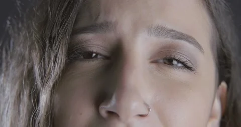 Close up young woman's sad eye. Unhappy, despair and hopeless girl's emotiona Stock Footage 139825293