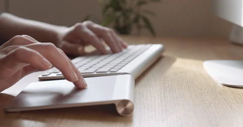 Close-Up Of Young Women Hands Using Bluetooth Trackpad On Wooden Desk 4K Stock Footage 47488910