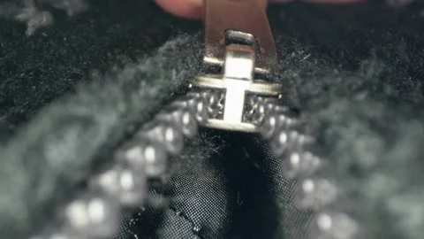 Close up of zipper being slowly pulled down Stock Footage 169390897