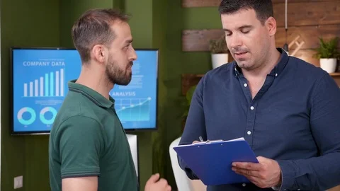 Close up zoom in portrait of two office colleagues having a conversation Stock Footage 112654042