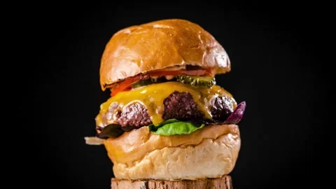 Close up zoom shot of large appetizing burger grilled steak. vegetables, Video stock 336579123