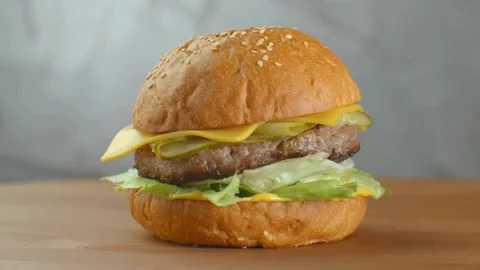 Close up zoom shot of large appetizing burger grilled steak. vegetables, Stock-Footage 336579410