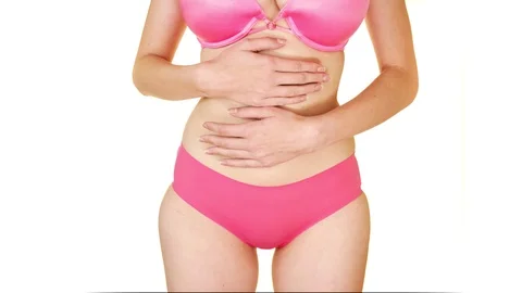 Close Up Of Woman In Underwear Holding Stomach In Pain Stock Photo
