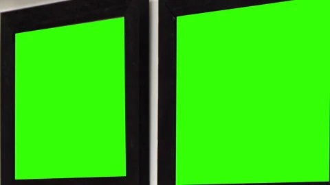 Close-Up Zoom-In of Two Black Frames With Green Chroma Screens Hanging on Wall Stock Footage 305194747