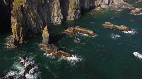Closed and static shot of waves impacting on rocks of the atlantic ocean in d Stock Photos