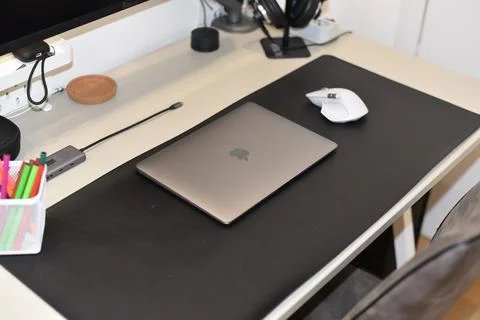 Closed Apple MacBook laptop, MX Master mouse and USB-C hub Stock Photos