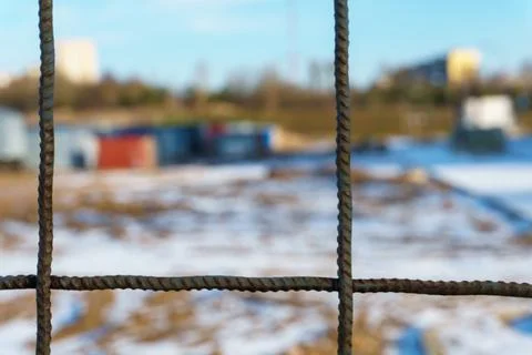 The closed area of the construction site in winter. A metal fence made of reb Stock Photos
