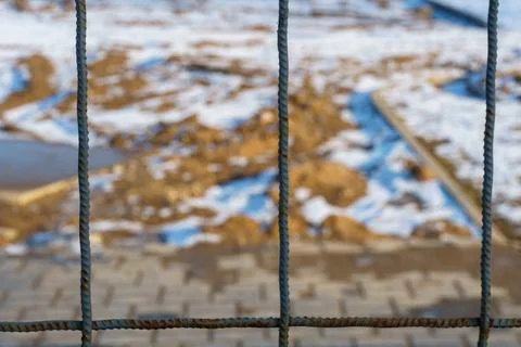 The closed area of the construction site in winter. A metal fence made of reb Stock Photos