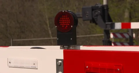 Closed automatic boom barriers in a railway level crossing Stock Footage 77510453