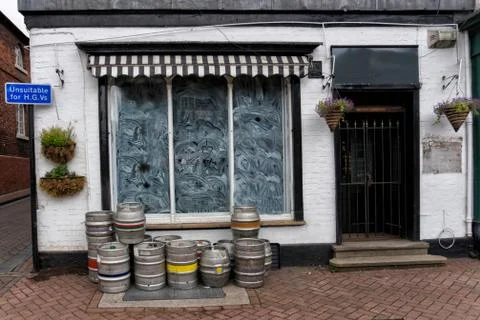 Closed bar due to coronavirus covid-19 shows barrels and whitewashed windows Stock Photos