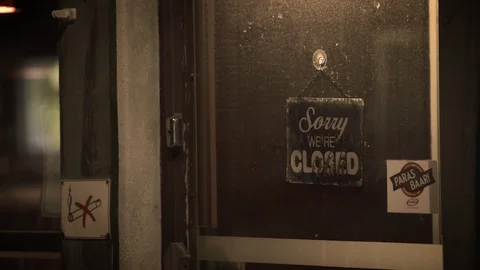 Closed bar / restaurant door with worn out closed sign [Exterior, Night] Stock Footage 129291709