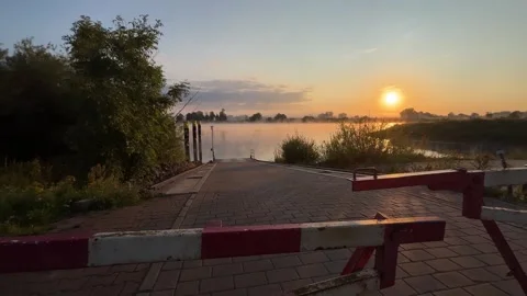 Closed Barrier at Ferry Landing During Sunrise Stock Footage 342316665