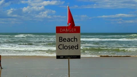Closed Beach Sign at busy beach, closed due to big swell Stock Footage 219863058
