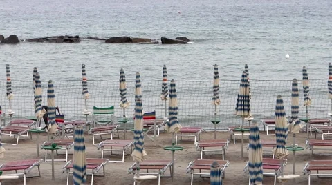 Closed beach umbrellas, beach at sunset Stock Footage 41380253