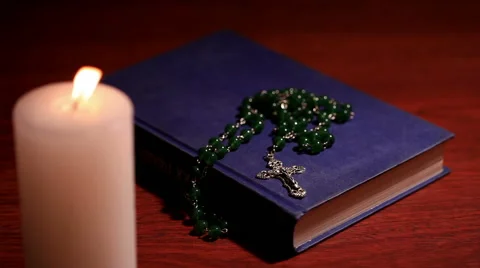 A closed bible with a rosary Stock Footage 58314054