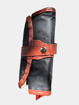 Closed black canvas pouch with brown leather trim. 写真素材