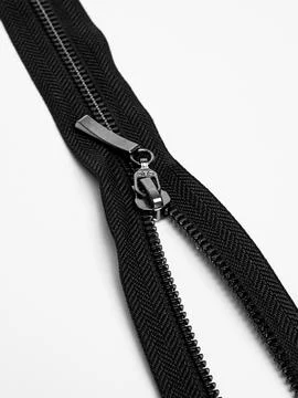 Closed black zipper with metal pull close up Stock Photos