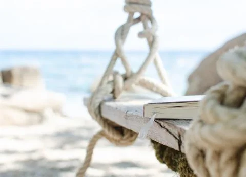 Closed book on beach swing Stock Photos