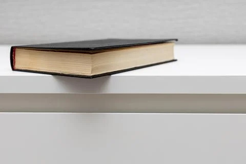 A closed book lies on the table. Stock Photos