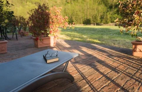 Closed book on the table in front of blurred nature landscape Stock Photos