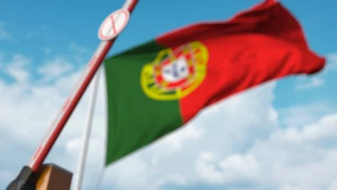 Closed boom gate with STOP CORONAVIRUS sign on the Portuguese flag background Stock Footage 126538669