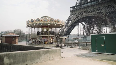 Closed carousel and deserted Eiffel tower during coronavirus lockdown in Paris Stock Footage 126753276