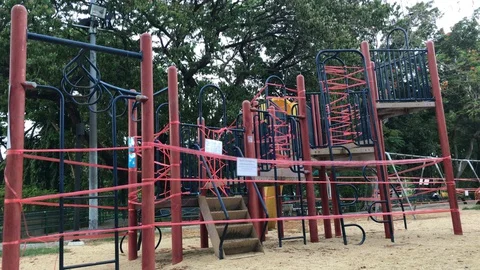 Closed children's playground at Park Because of Coronavirus Measures - COVID-19 Stock Footage 130097096
