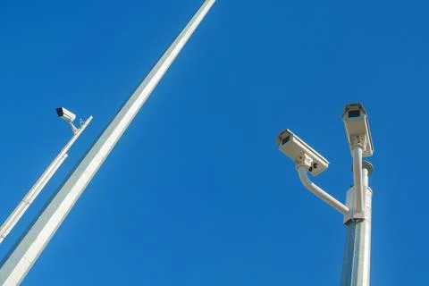 Closed-circuit television cameras against a clear blue sky Stock Photos