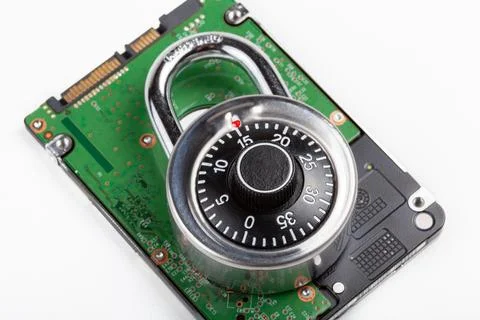 Closed code padlock laying on top of a HDD hard drive, object detail, close.. Foto stock