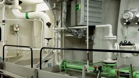 Closed conduits and pumps extend across tanker engine room Video stock 121119581