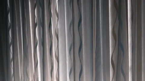 Closed curtains swaying in a light breeze Stock Footage 219864778