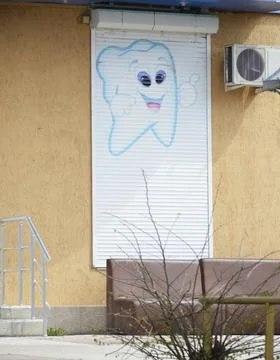 Closed dentistry window with a drawn tooth Stock Photos