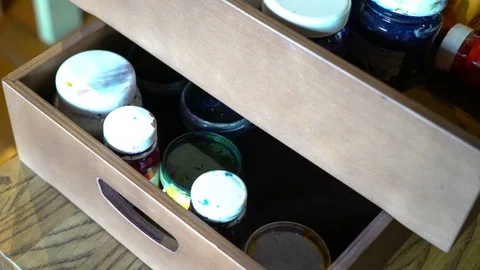 Closed different color oil jars folded in box. Panorama Stock Footage 74288494