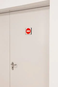 A closed door features a red no entry sign clearly positioned above the han.. Stock Photos