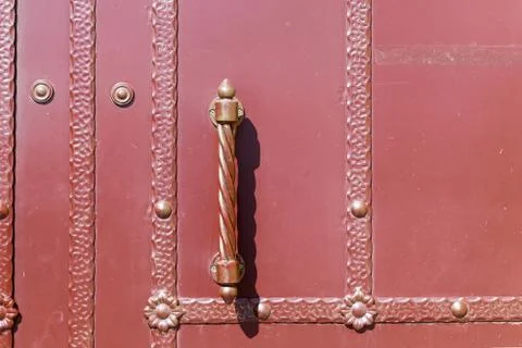 A closed door with the patterns on the strips. The vertical handle of the doo Foto stock